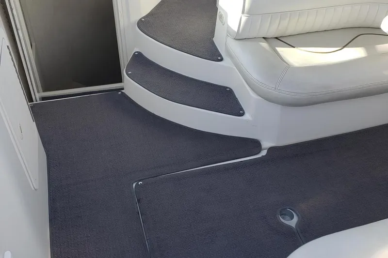 Slide: The Image of 1998 Cruisers 2870 Rogue boat interior with carpeted steps and seating area. - 7