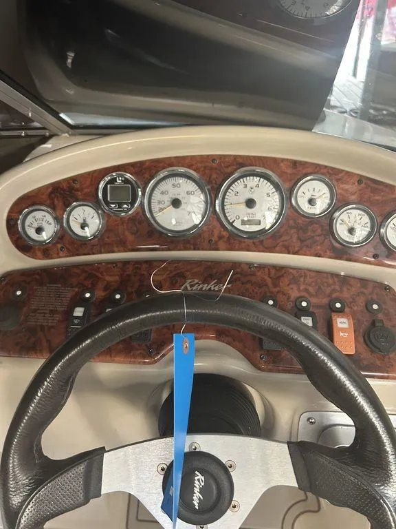 Slide: The Image of 2003 Rinker RX1 boat dashboard with gauges and steering wheel. - 11