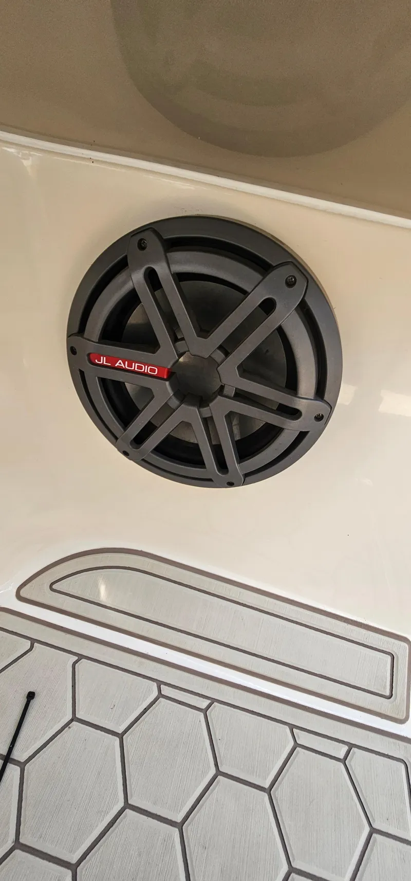 Slide: The Image of JL Audio speaker on a 2003 Rinker RX1 boat interior. - 14