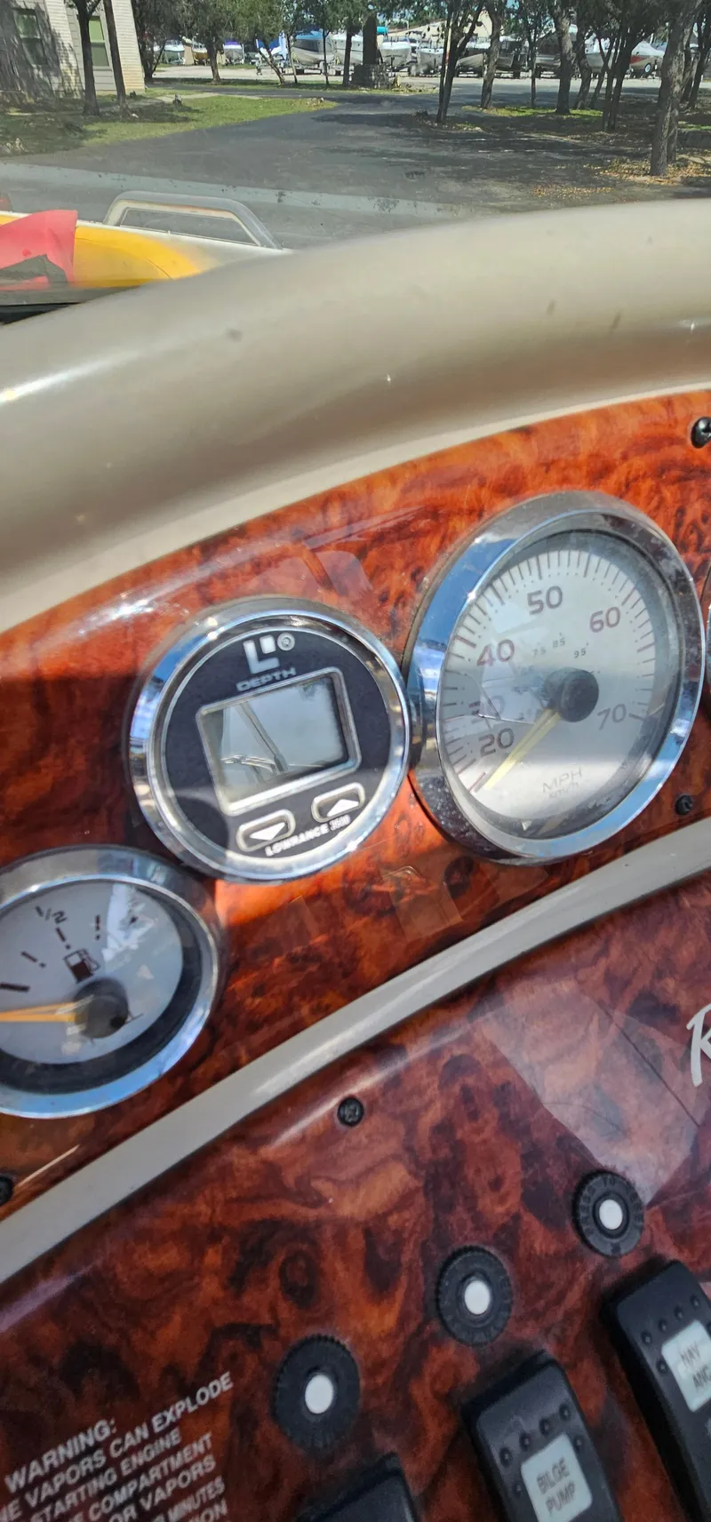 Slide: The Image of Dashboard of a 2003 Rinker RX1 boat with gauges and controls. - 15