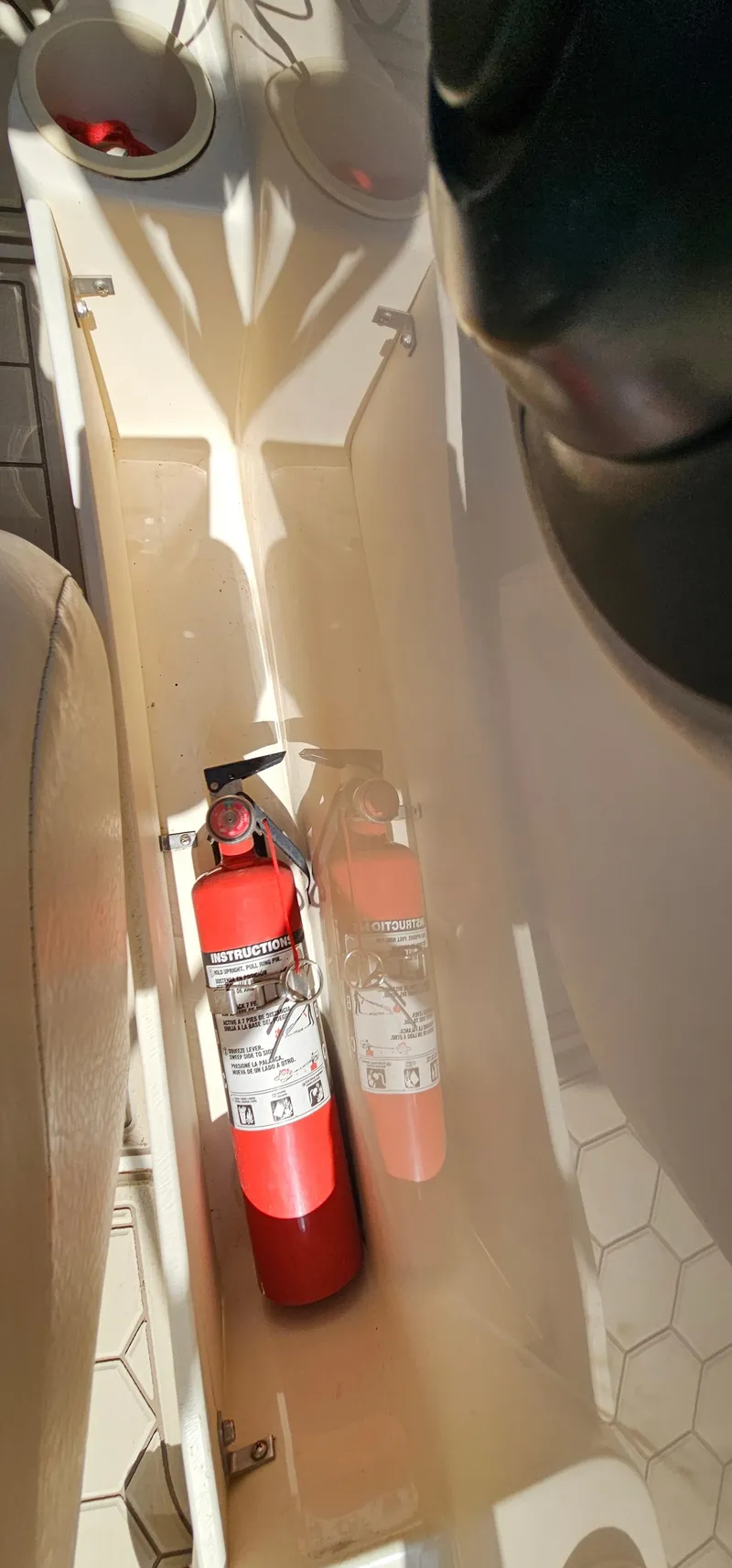 Slide: The Image of Fire extinguisher in a 2003 Rinker RX1 boat compartment. - 21