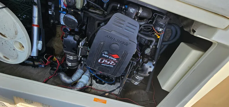 Slide: The Image of Engine compartment of a 2003 Rinker RX1 boat, featuring a MerCruiser 5.0L engine. - 22