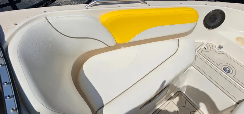 Slide: The Image of 2003 Rinker RX1 boat interior with white and yellow seating. - 3