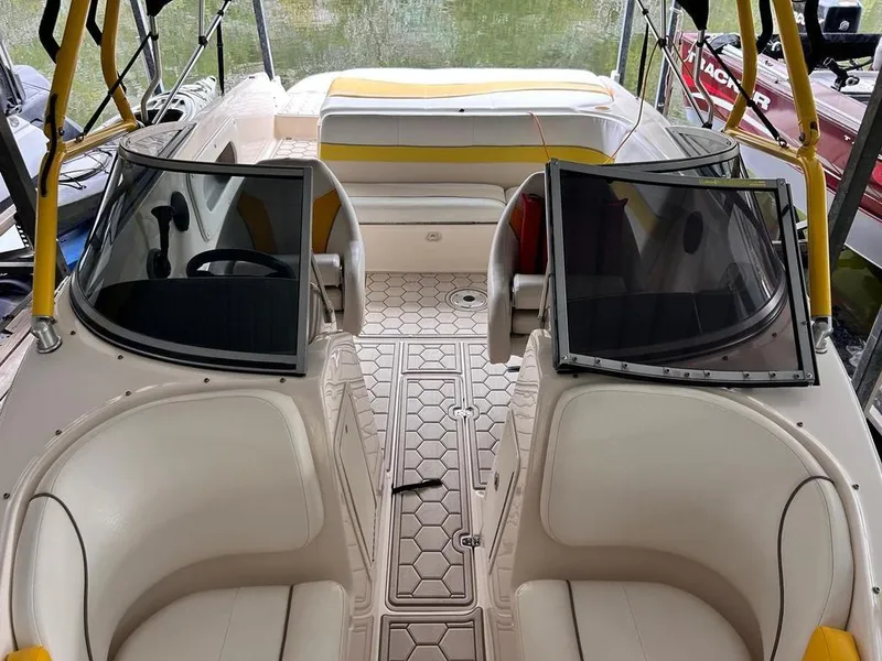 Slide: The Image of 2003 Rinker RX1 boat interior with white seating and yellow accents. - 8