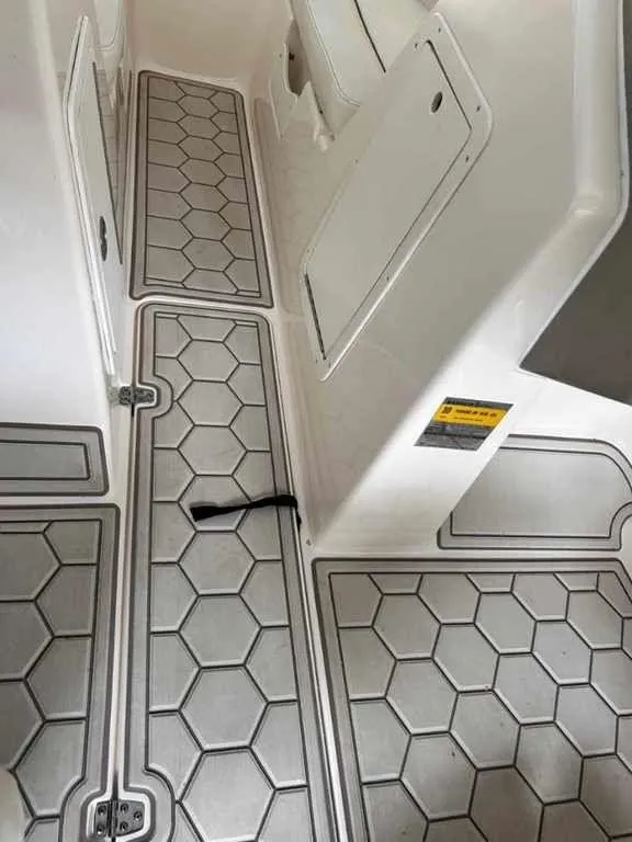 Slide: The Image of 2003 Rinker RX1 boat interior with hexagonal patterned flooring. - 9