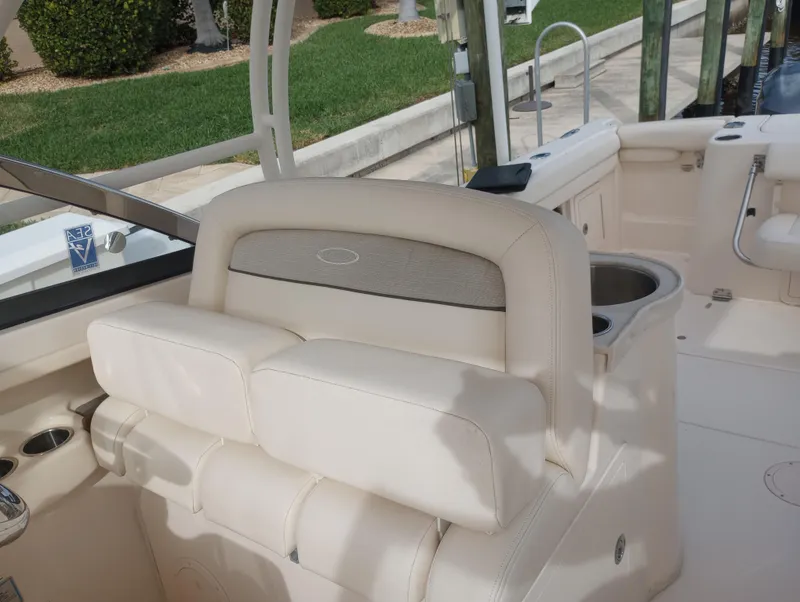 Slide: The Image of 2016 Grady-White Freedom 307 boat with dual engines and seating, docked by the water. - 14