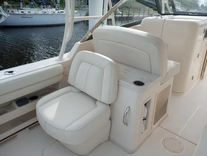 Slide: The Image of 2016 Grady-White Freedom 307 boat interior with seating and open deck view. - 17