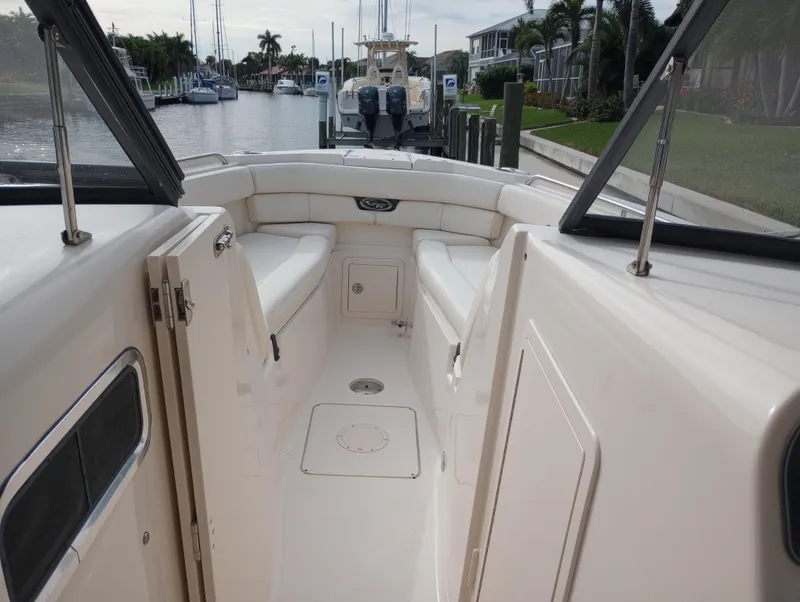 Slide: The Image of Grady-White Freedom 307 boat interior, 2016 model, featuring seating and cup holders. - 18