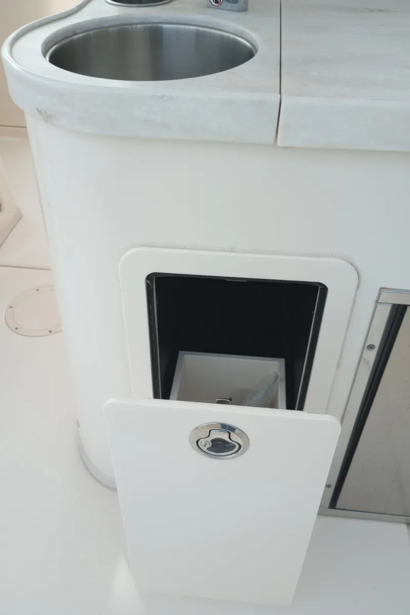 Slide: The Image of Storage compartment with life jackets on a 2016 Grady-White Freedom 307 boat. - 25