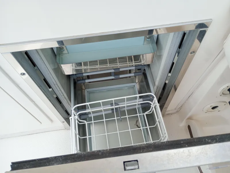 Slide: The Image of 2016 Grady-White Freedom 307 boat console with Fusion stereo system and cup holder. - 26