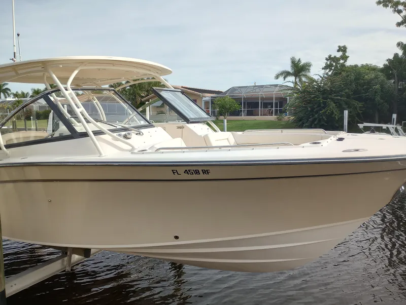 Slide: The Image of 2016 Grady-White Freedom 307 boat interior with white seating and cup holders. - 9