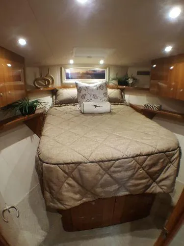 Slide: The Image of Luxurious cabin interior of 2016 Viking 42 Open yacht with cozy bedding and elegant wood finishes. - 10
