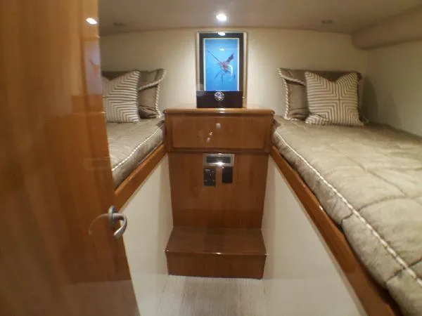 Slide: The Image of 2016 Viking 42 Open cabin with twin beds and wooden interior. - 11