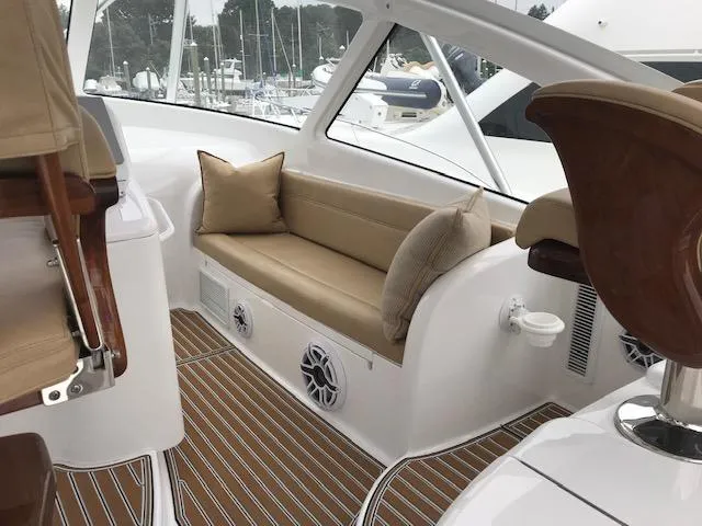 Slide: The Image of 2016 Viking 42 Open yacht interior with cushioned seating and wood accents. - 13