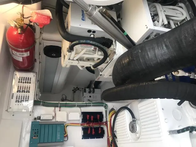 Slide: The Image of Engine room of 2016 Viking 42 Open yacht with fire extinguisher and electrical components. - 16