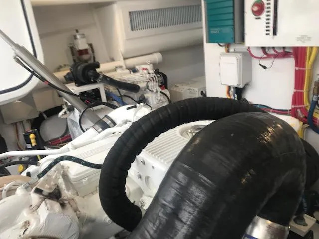 Slide: The Image of Engine room of 2016 Viking 42 Open yacht, showcasing mechanical components and wiring. - 17