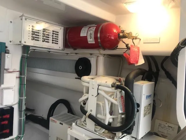 Slide: The Image of Engine room of 2016 Viking 42 Open with fire suppression system and machinery. - 18