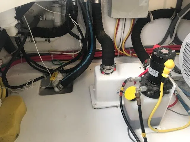 Slide: The Image of Engine room of 2016 Viking 42 Open boat, showing wiring and mechanical components. - 23