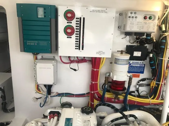 Slide: The Image of Engine room of 2016 Viking 42 Open with electrical panels and wiring. - 25