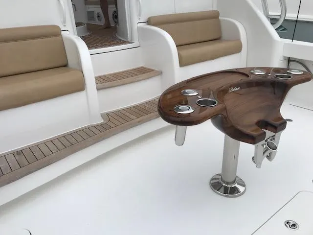 Slide: The Image of 2016 Viking 42 Open yacht interior with seating and wooden table. - 27