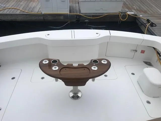 Slide: The Image of 2016 Viking 42 Open yacht deck with fishing rod holders and seating area. - 28