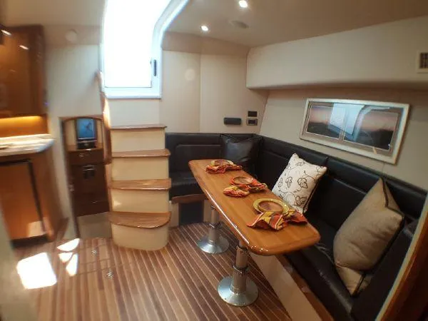 Slide: The Image of 2016 Viking 42 Open yacht interior with dining area and staircase. - 7