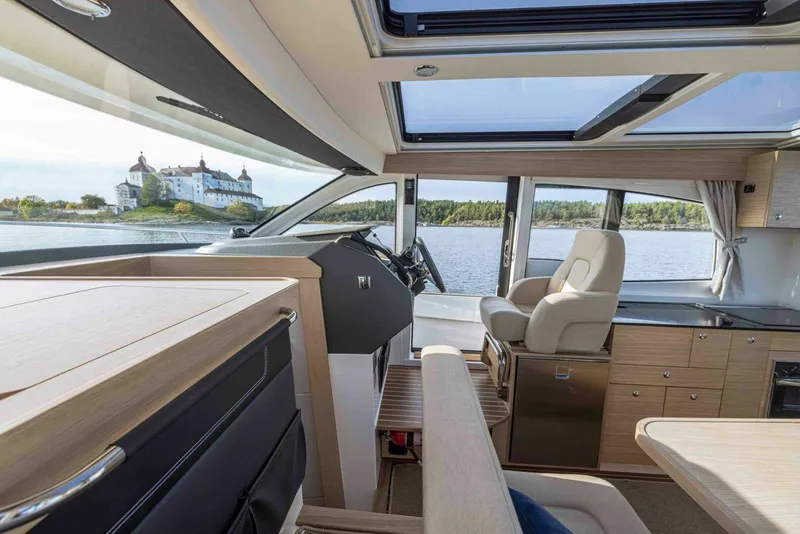 Slide: The Image of Interior of 2025 Nimbus 365 Coupe yacht with scenic water view. - 12