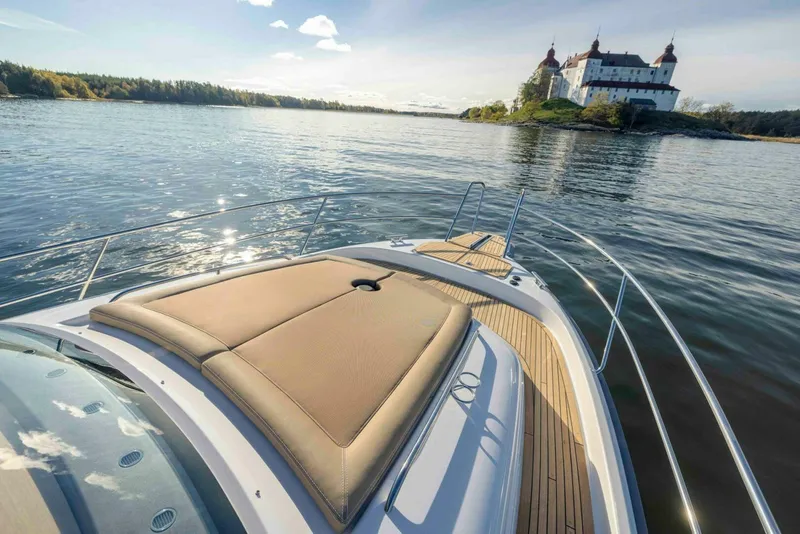 Slide: The Image of Nimbus 365 Coupe 2025 cruising near a scenic castle on a sunny day. - 6