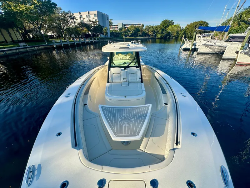 Slide: The Image of 2025 Scout 425 LXF boat on calm water, showcasing sleek design and luxury features. - 13