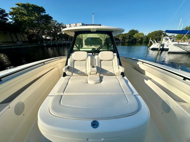 Slide: The Image of 2025 Scout 425 LXF boat with sleek design on calm water. - 14