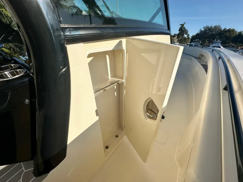 Slide: The Image of 2025 Scout 425 LXF boat storage compartment with open door, showcasing interior space. - 18