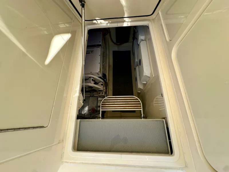 Slide: The Image of 2025 Scout 425 LXF boat interior with open hatch and visible ladder. - 19