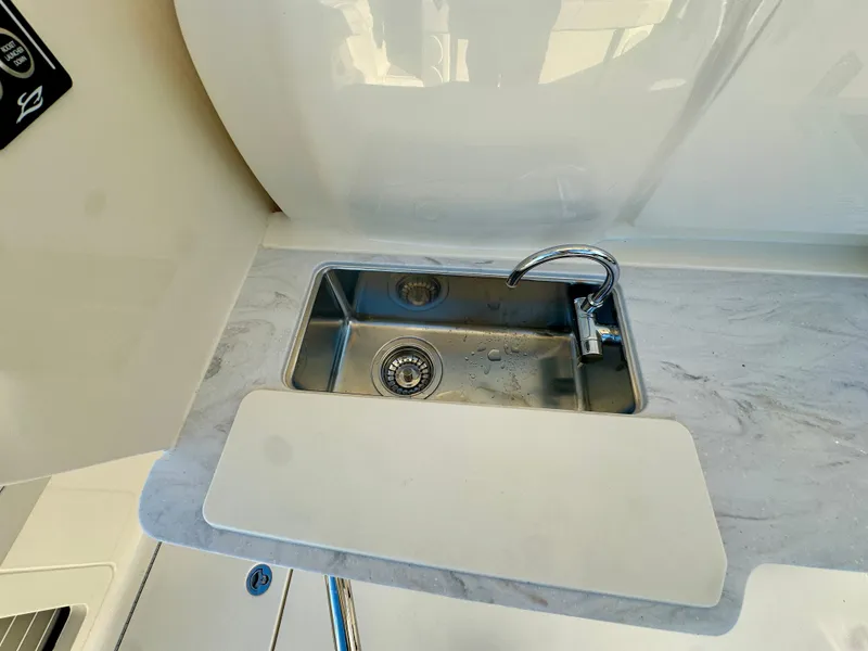 Slide: The Image of Stainless steel sink on 2025 Scout 425 LXF boat with marble countertop. - 23
