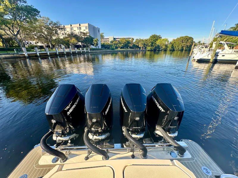 Slide: The Image of 2025 Scout 425 LXF boat with four Mercury outboard engines on a calm river. - 24
