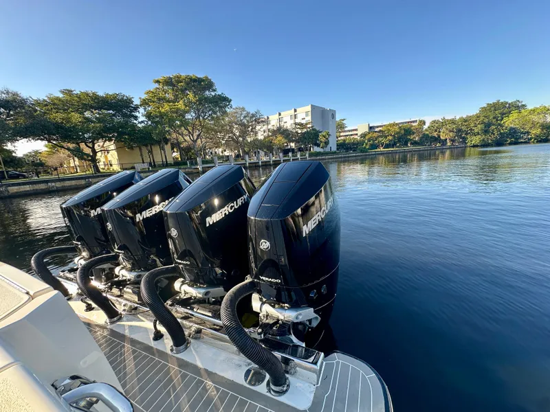 Slide: The Image of 2025 Scout 425 LXF boat with four Mercury outboard engines on a calm lake. - 25