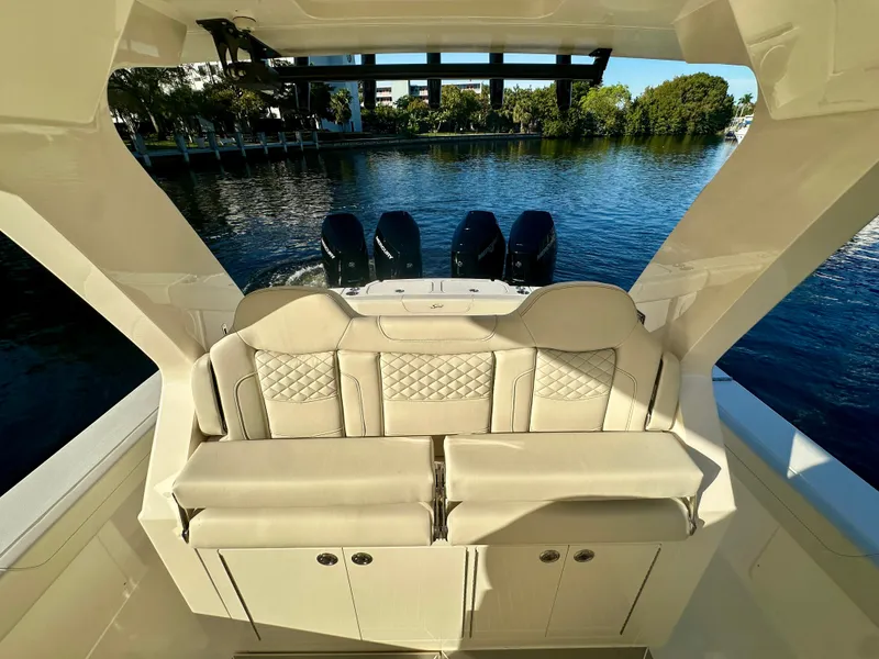 Slide: The Image of 2025 Scout 425 LXF luxury boat interior with plush seating and quad engines. - 8