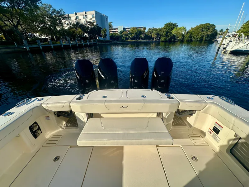 Slide: The Image of 2025 Scout 425 LXF boat with four engines, docked on a sunny day. - 9