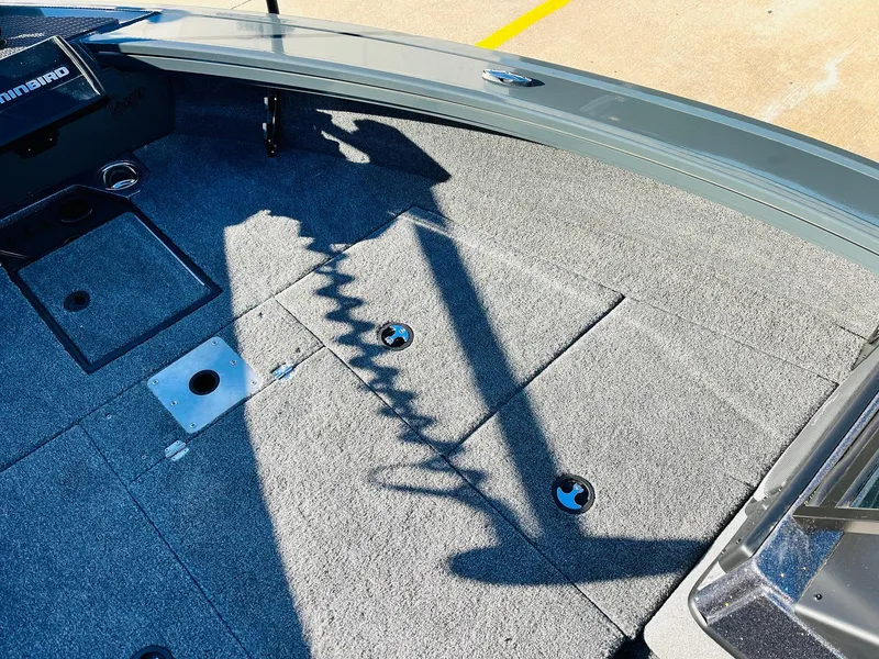 Slide: The Image of 2025 Ranger VX1988 WT boat interior with carpeted deck and storage compartments. - 17