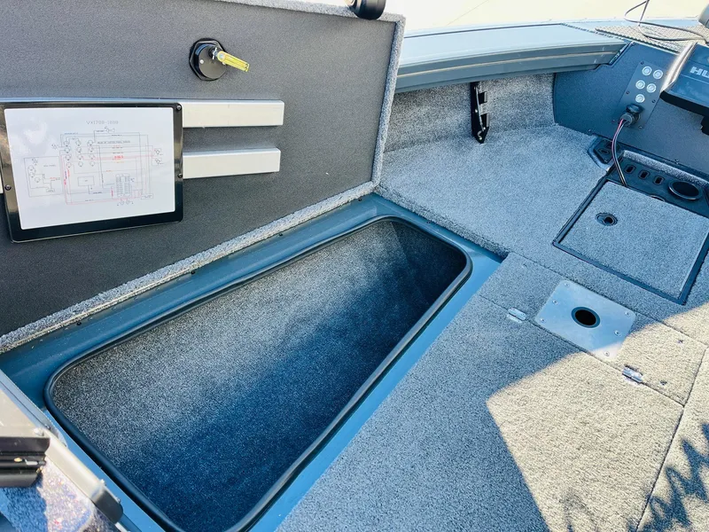 Slide: The Image of 2025 Ranger VX1988 WT boat interior with storage compartment and control panel. - 18