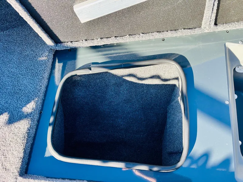 Slide: The Image of Storage compartment in 2025 Ranger VX1988 WT boat, featuring carpeted interior. - 22