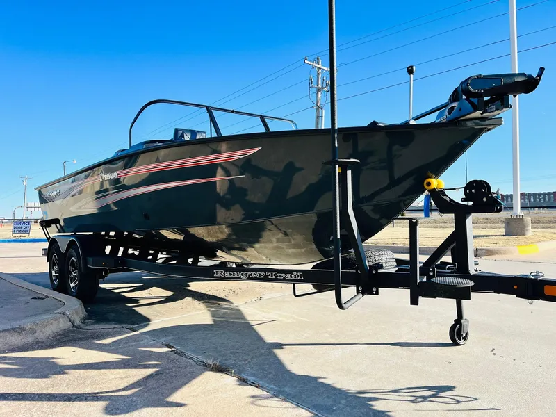 Slide: The Image of 2025 Ranger VX1988 WT boat on trailer, sleek design, parked outdoors under clear blue sky. - 3