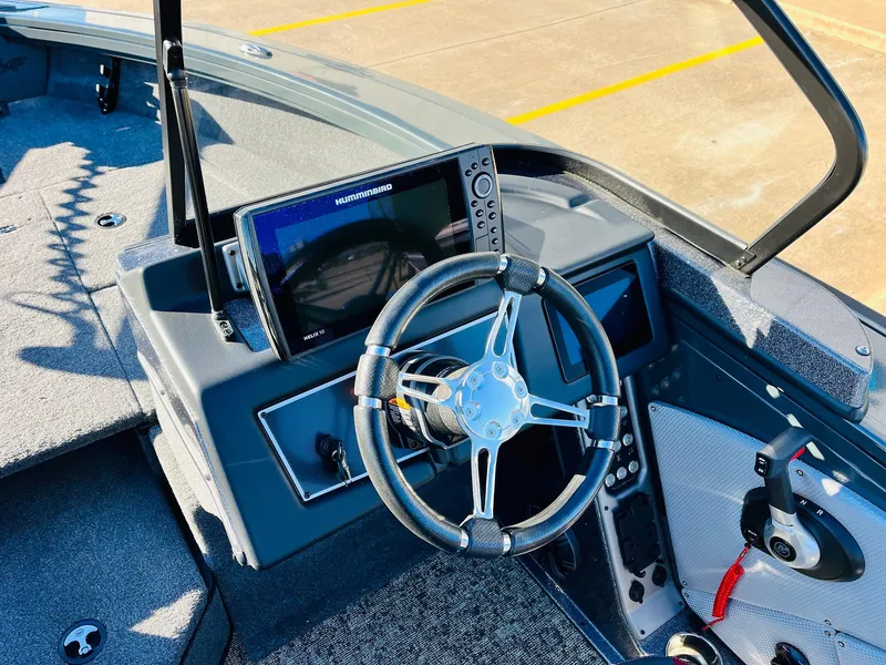 Slide: The Image of 2025 Ranger VX1988 WT boat dashboard with steering wheel and navigation system. - 34