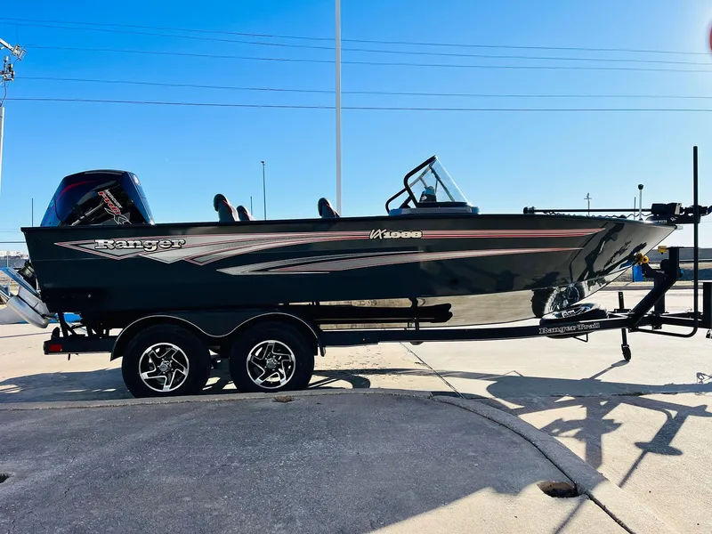 Slide: The Image of 2025 Ranger VX1988 WT boat on trailer, sleek black design, parked outdoors. - 4