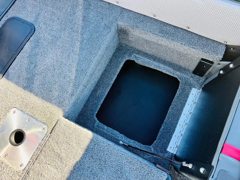 Slide: The Image of 2025 Ranger VX1988 WT boat interior with storage compartment and carpeted flooring. - 49