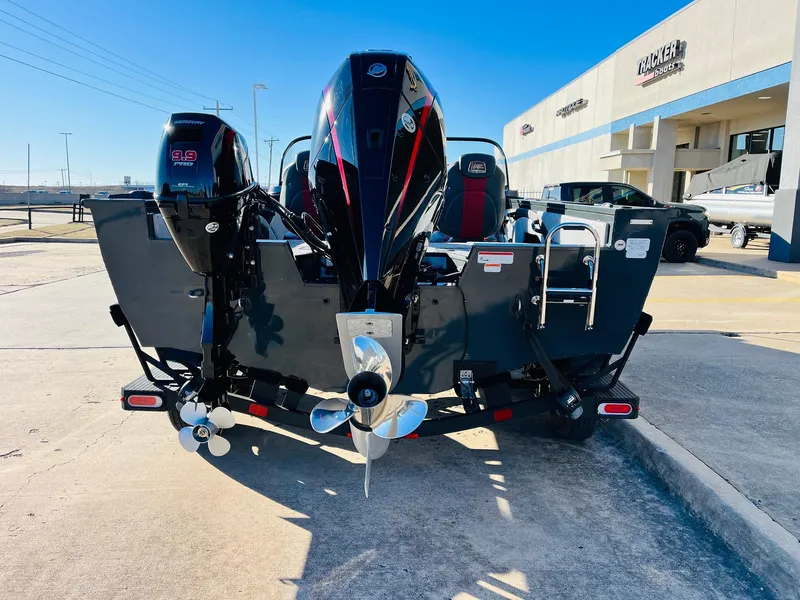 Slide: The Image of 2025 Ranger VX1988 WT boat with dual engines, parked outdoors near dealership. - 6