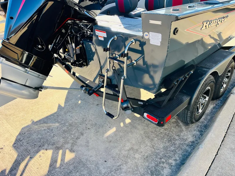 Slide: The Image of 2025 Ranger VX1988 WT boat on trailer, rear view with motor and ladder. - 9