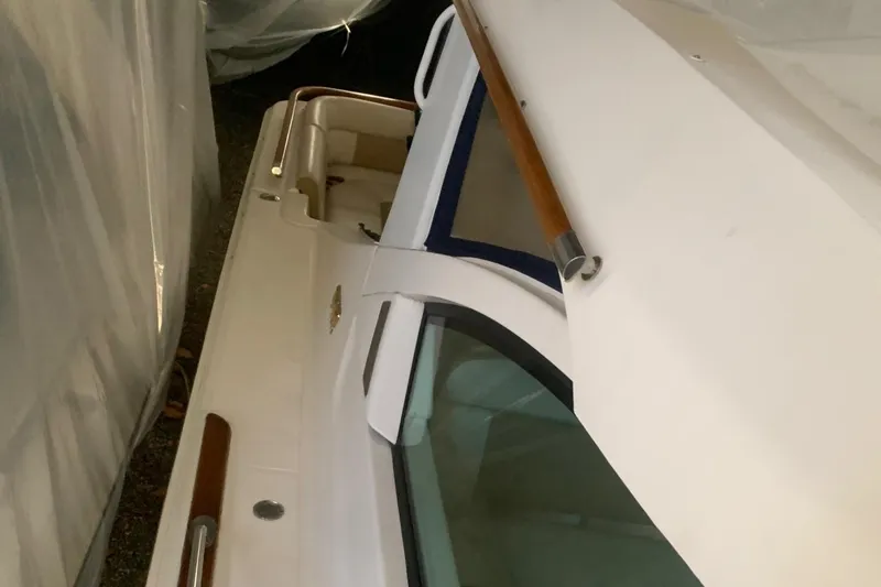 Slide: The Image of 2012 Tiara Yachts 3100 Coronet, side view with wooden handrails and sleek design. - 13