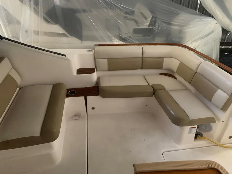 Slide: The Image of 2012 Tiara Yachts 3100 Coronet interior with beige seating and wood accents. - 3