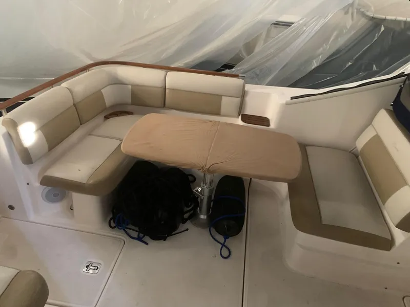 Slide: The Image of 2012 Tiara Yachts 3100 Coronet interior seating with table and storage. - 4