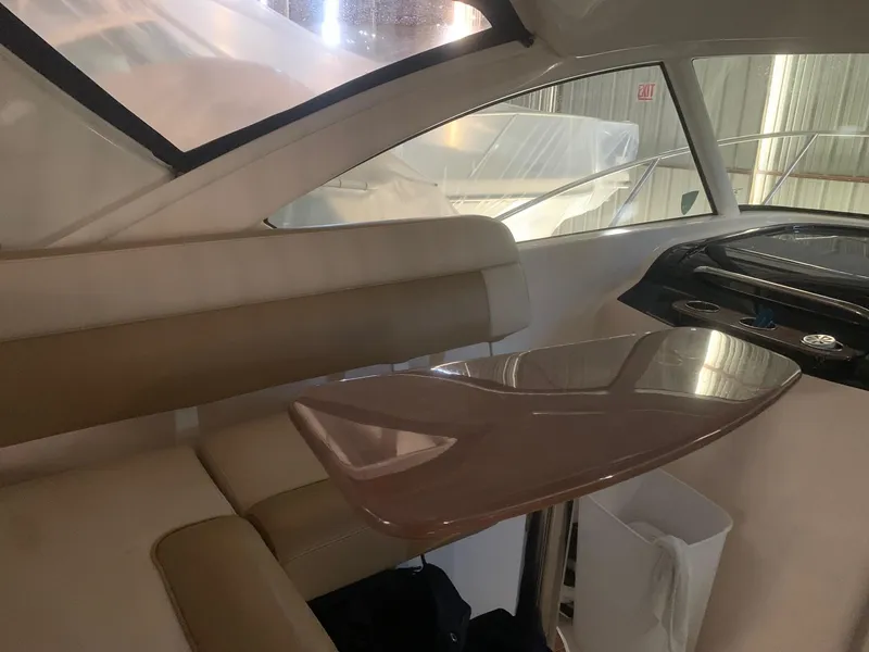 Slide: The Image of Interior of 2012 Tiara Yachts 3100 Coronet with sleek seating and table. - 6